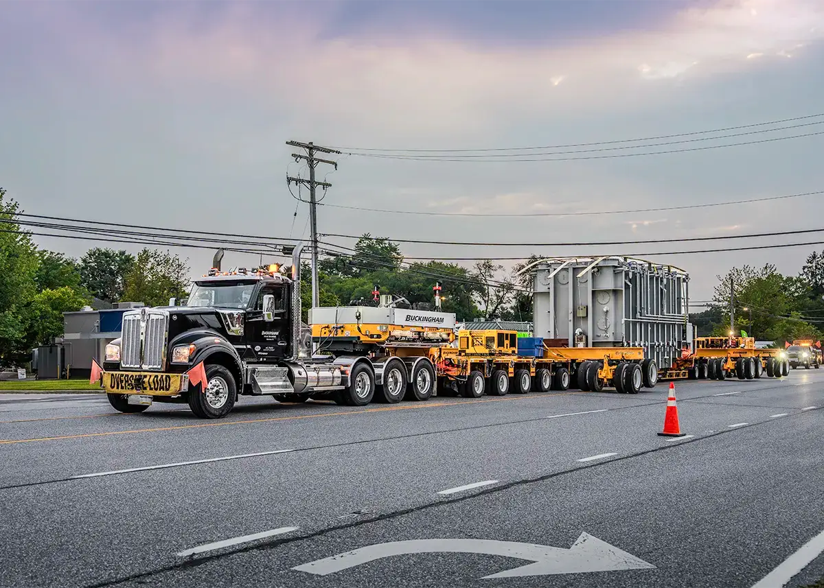 Buckingham Transport hauling transformer on yellow Goldhofer trailer